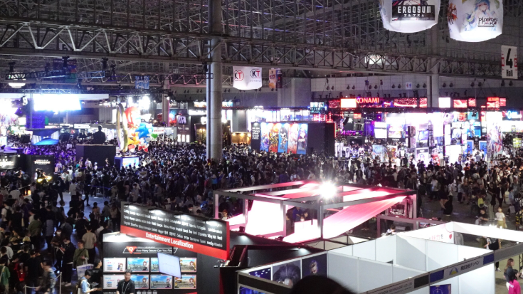 Huge crowds filling the exhibition halls at Tokyo Game Show 2025, with bright neon gaming booths and giant screens lighting up the space — capturing the excitement of the Tokyo game expo and why fans ask ‘when is Tokyo Game Show?’ each year to secure tickets early.