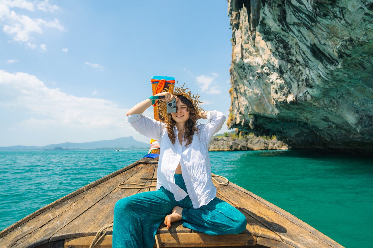 A woman traveling on a boat with a camera