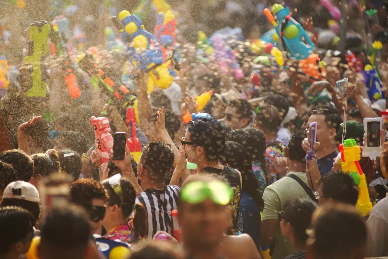 Water fight during Songkran, with people holding water guns.