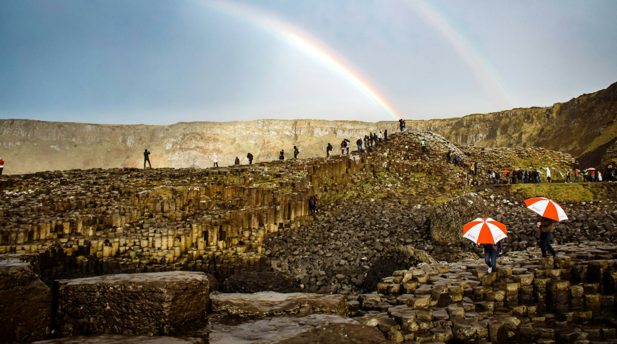Tourists walking along Giant's Causeway in Northern Ireland.