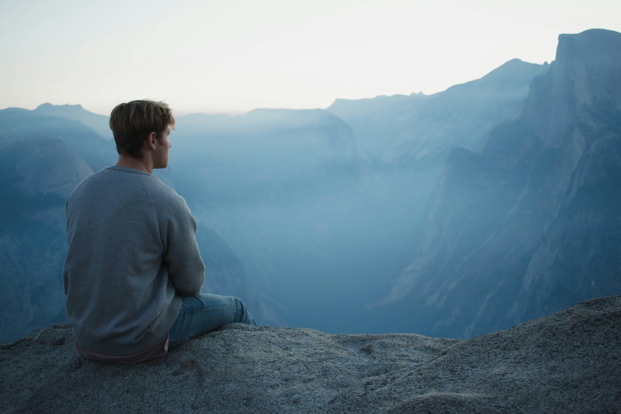 Man in a meditative state near mountains