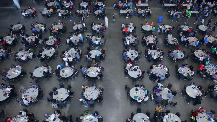 Gamers and fans gathering at communal tables during PAX West, highlighting the social side of the PAX event in Seattle - ideal for staying connected via an American eSIM while attending.
