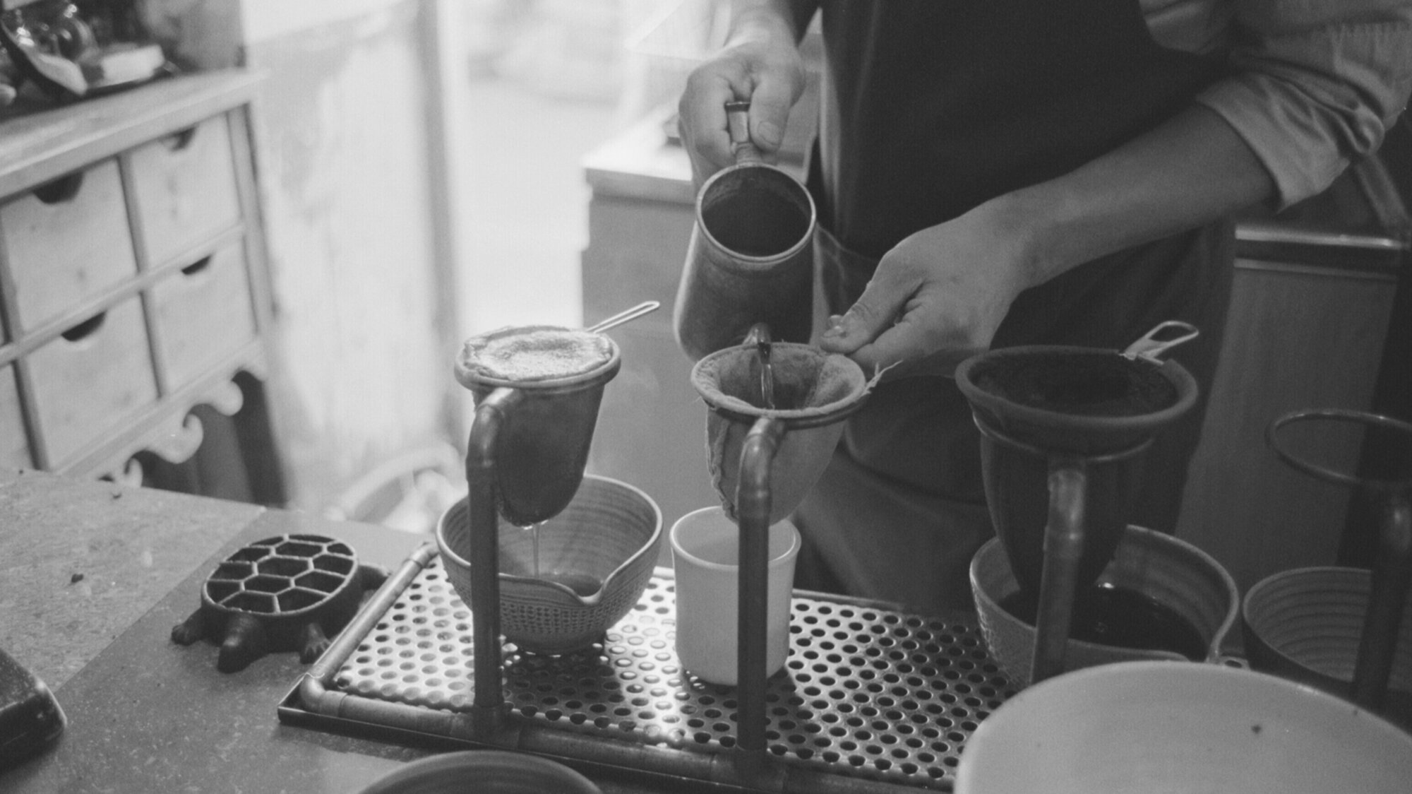 A Seoul barista careful pours coffee in a cafe