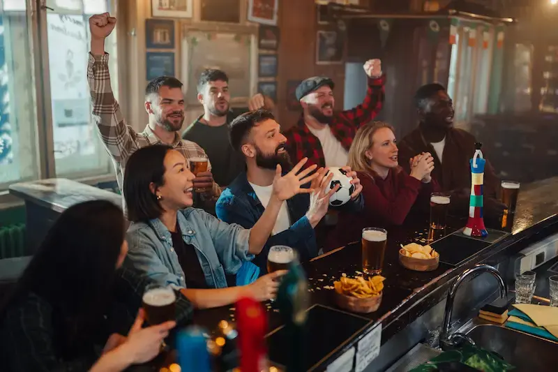 Grupo de amigos viendo fútbol en un bar en Canadá