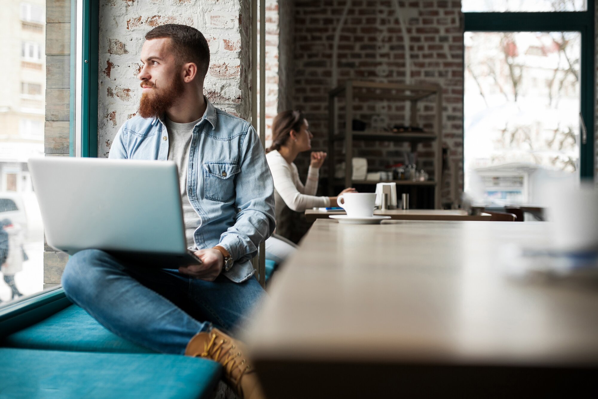 Man working on a laptop in a coffee shop