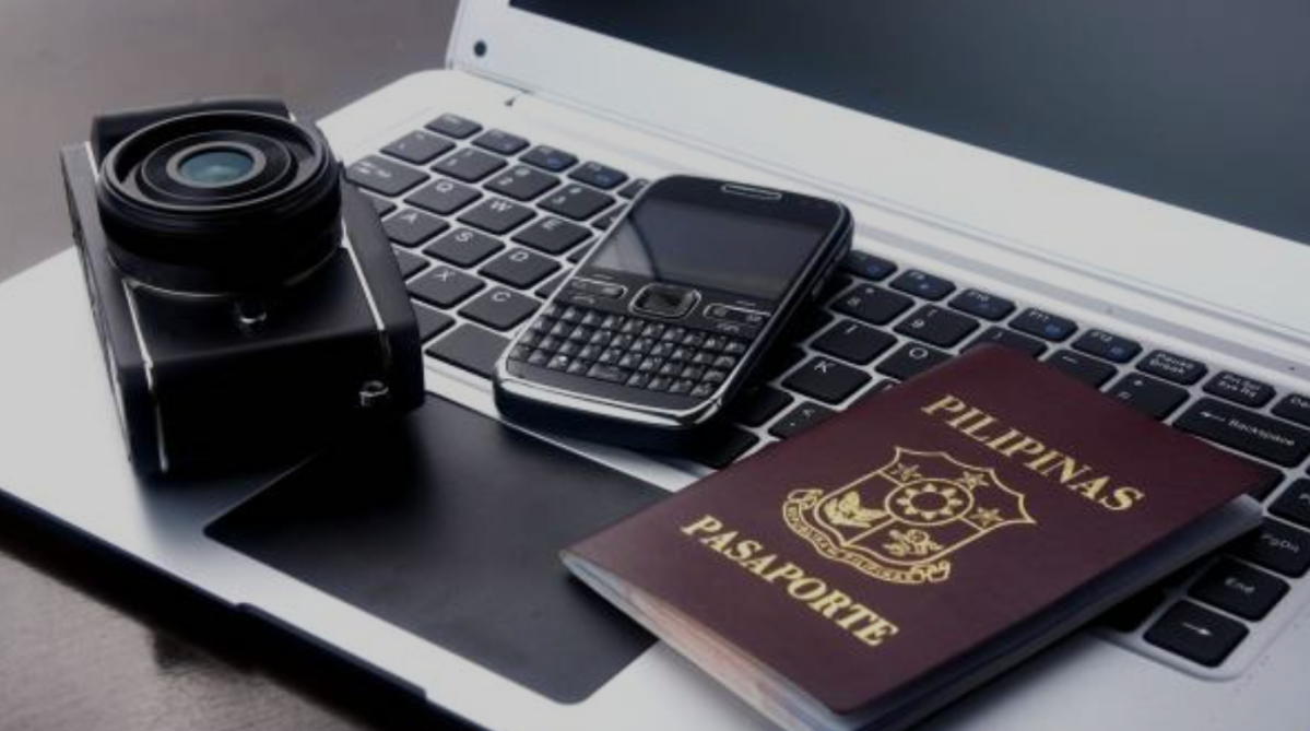 A Philippine passport on top of a laptop keyboard