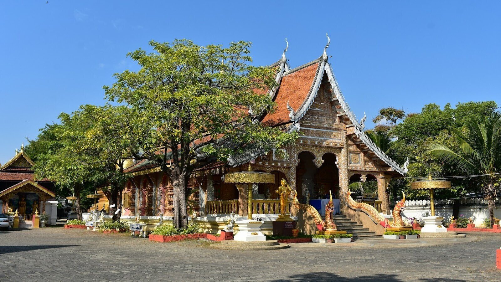 Buddhist temple in Chiang Mai’s old city surrounded by trees during the daytime