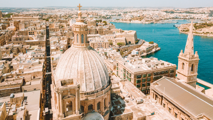 A colour photograph of Our Lady of Mount Carmel Basilica, a domed cathedral that overlooks Valletta, Malta.