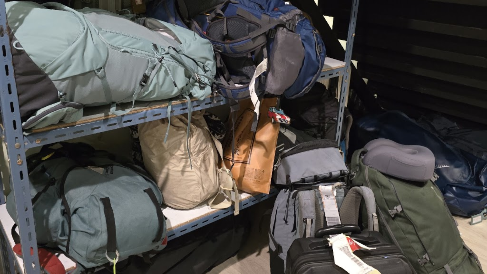 Backpacks on a shelf in a hostel