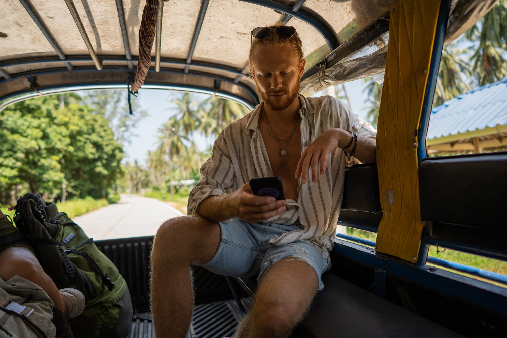 Tourist in the back of a car with an eSIM for Thailand