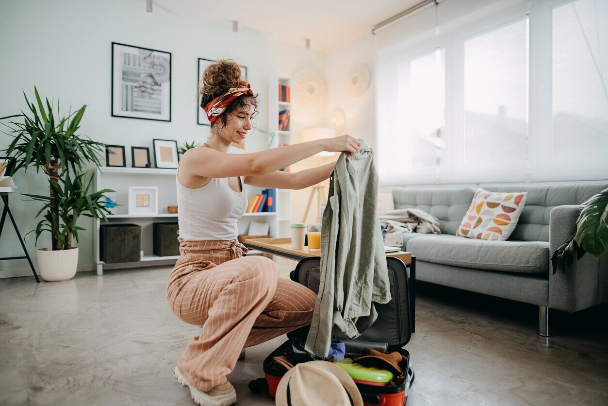 Woman packing a suitcase before her trip