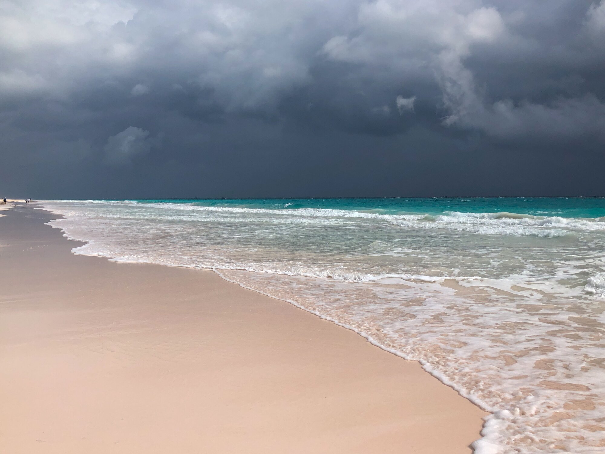Pink sand beach in the Bahamas, with stormy sky