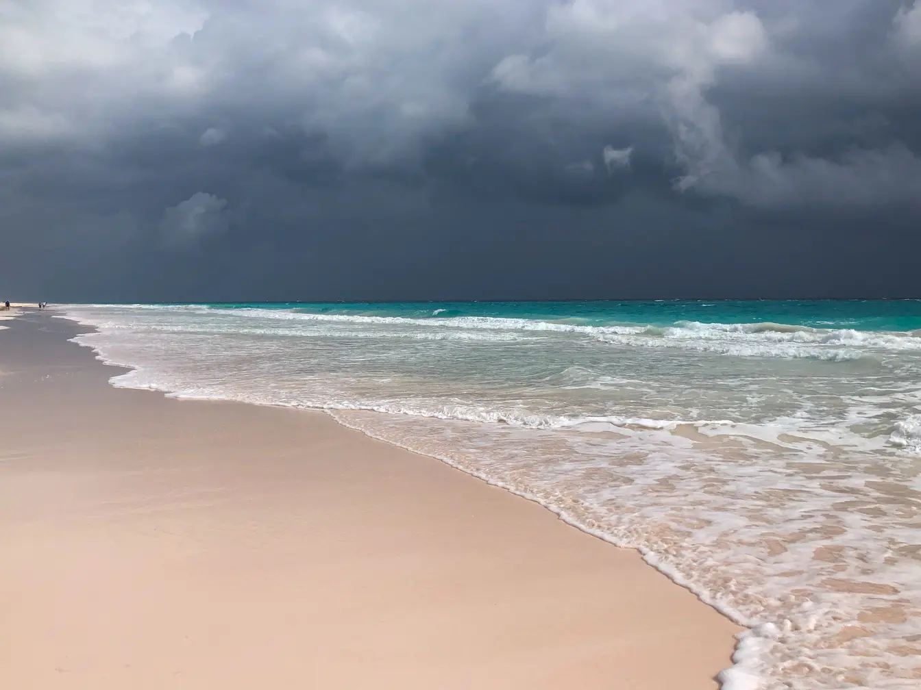 Pink sand beach in the Bahamas, with stormy sky