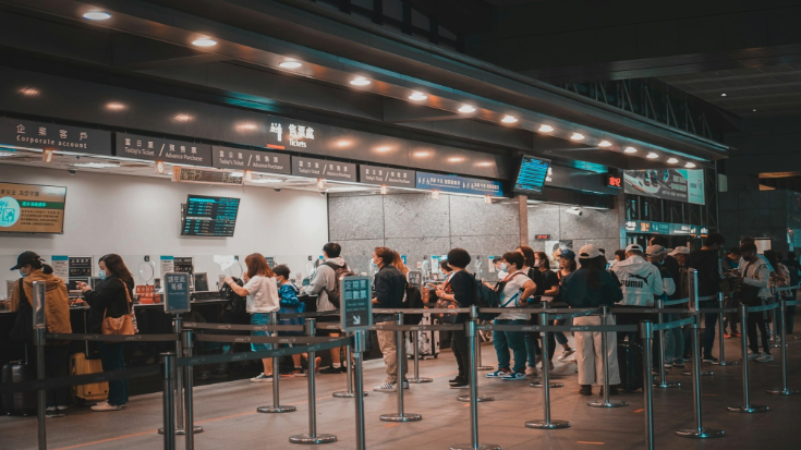 People queueing in an HSR train station to book tickets.