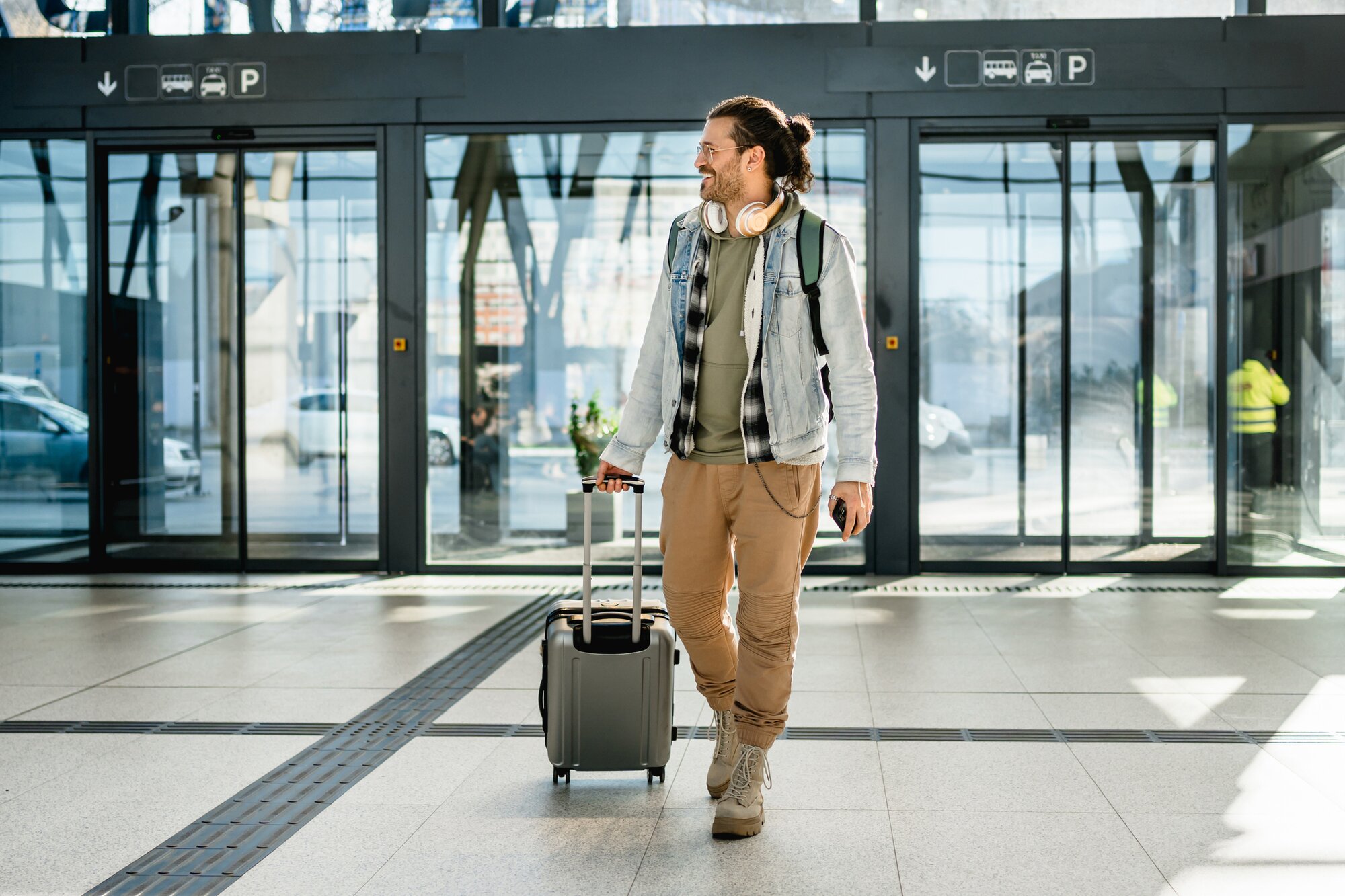 Tourist with suitcase and phone in his hand