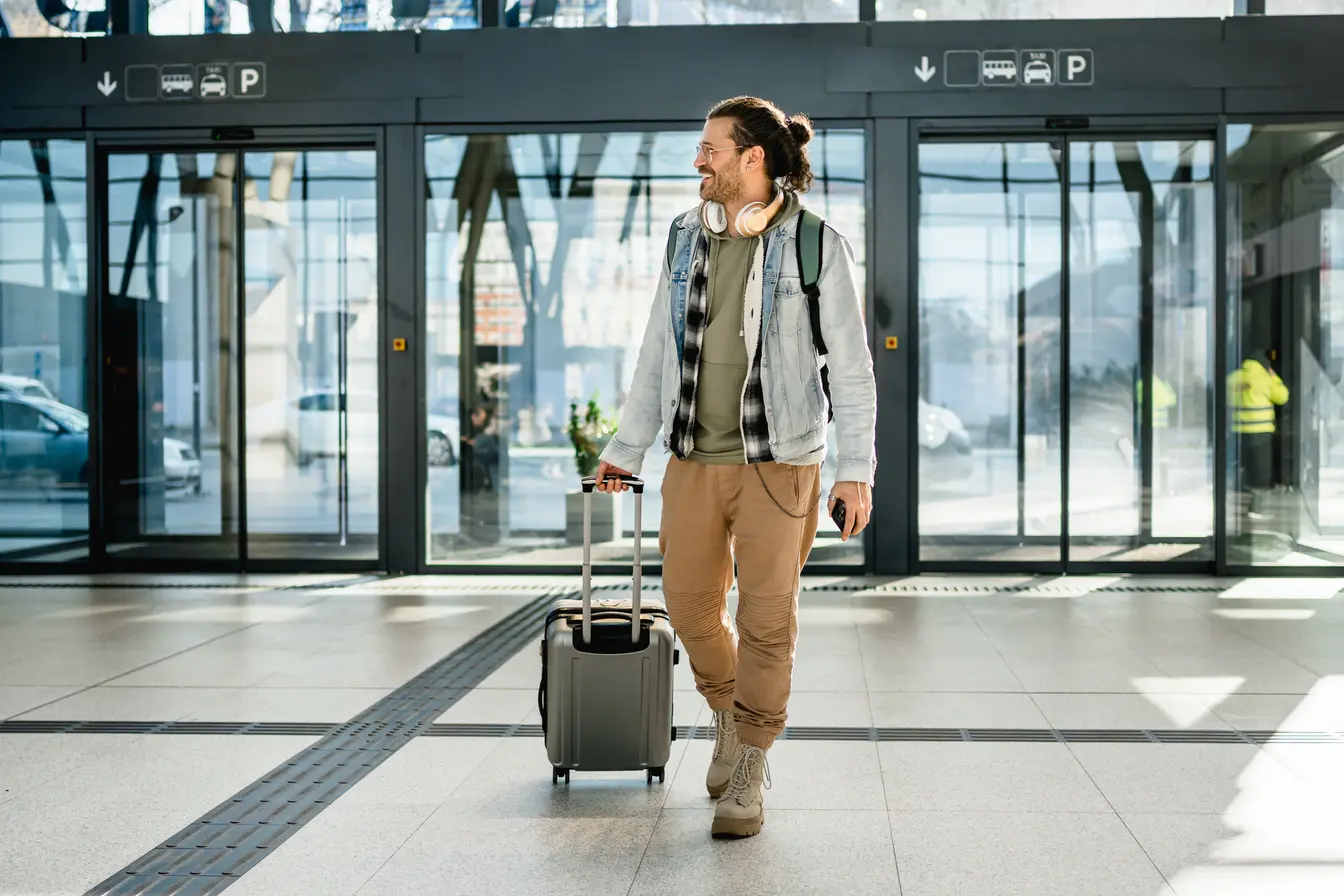 Tourist with suitcase and phone in his hand