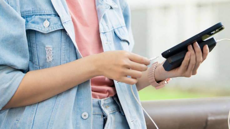 A person holding a smartphone showing the Airalo app, demonstrating the ease and convenience of getting a Japanese eSIM for travel.