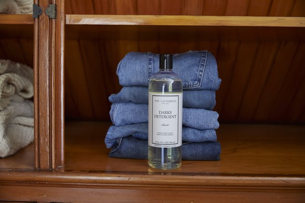darks detergent from the laundress in front of denim pile