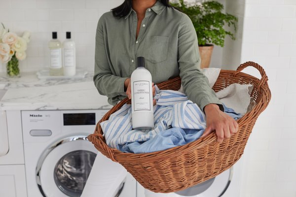 Woman holding The Laundress Fabric Conditioner