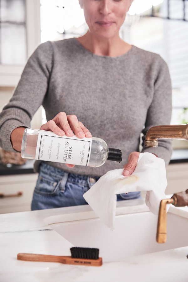 woman treating white napkin with the laundress stain solution