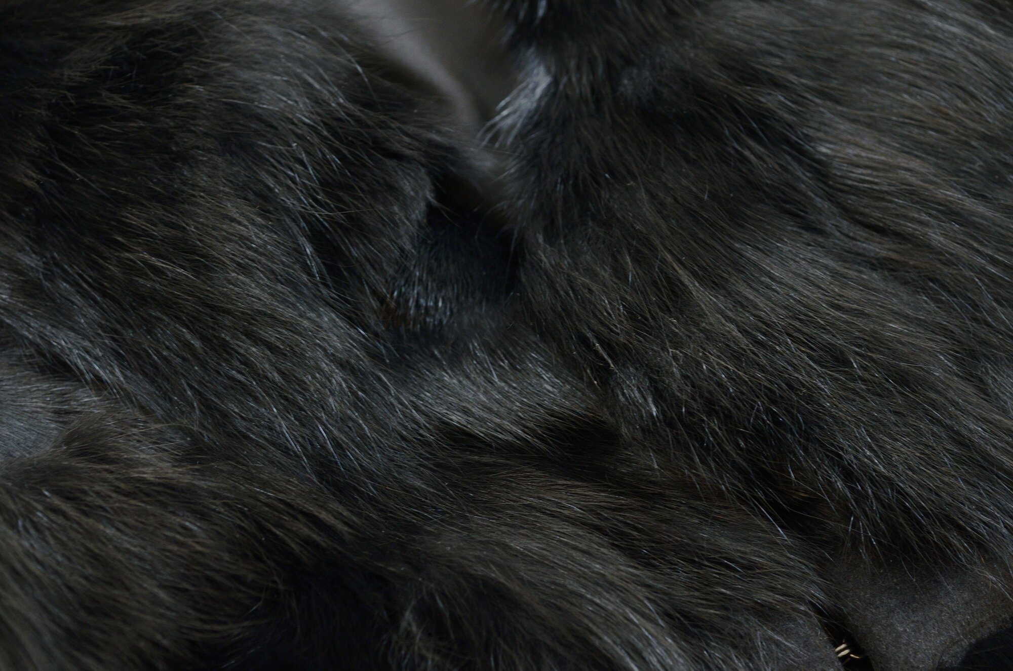 A close-up of the dense dark fur of a faux fur garment, which has been cleaned using The Laundress' method for dry cleaning.