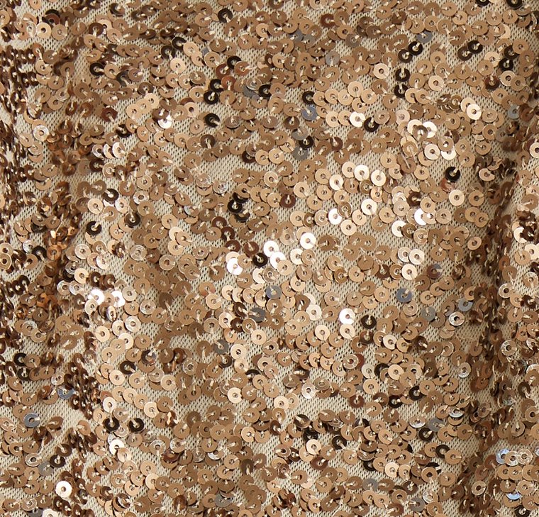 A close-up of gold sequined fabric, about to be washed with The Laundress method for washing embellished items.