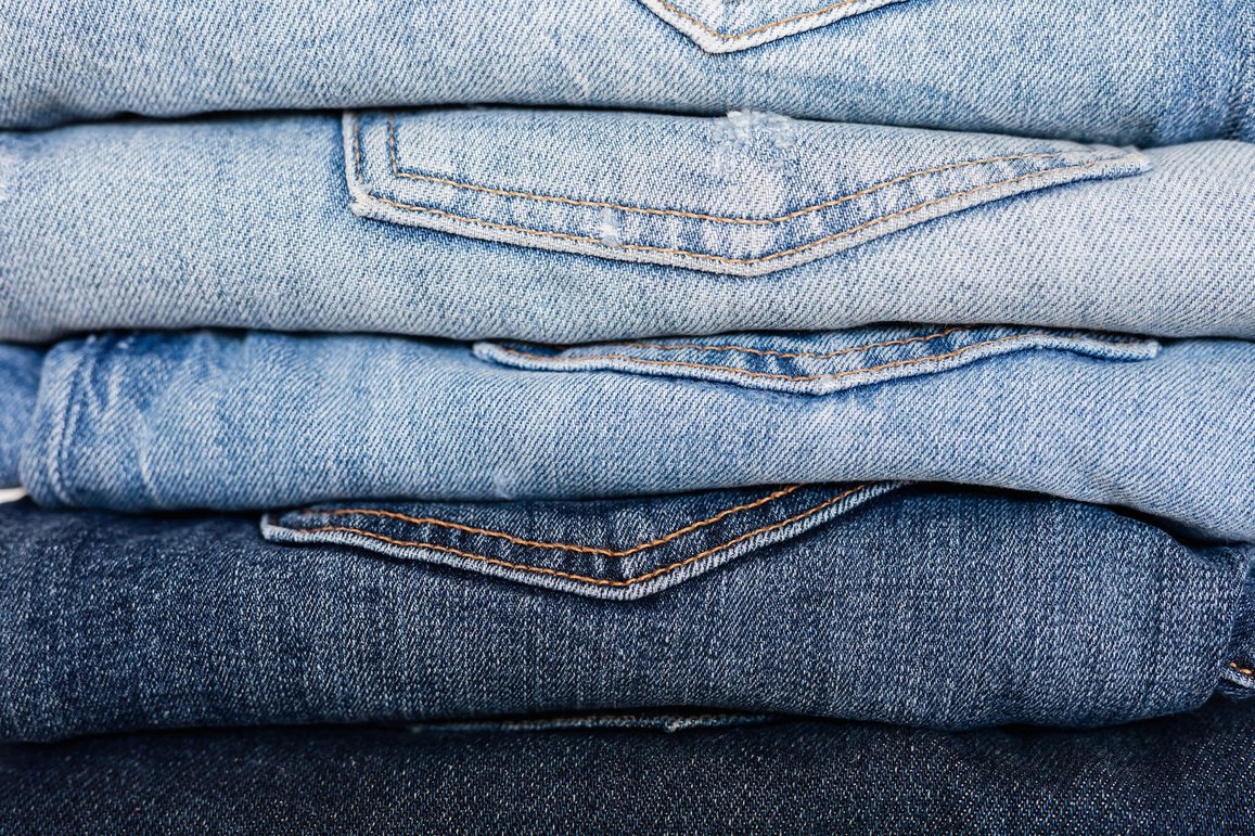 Folded denim jeans going from light to dark.