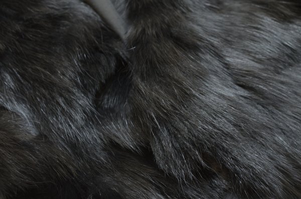A close-up of the dense dark fur of a faux fur garment, which has been cleaned using The Laundress' method for cleaning faux fur.