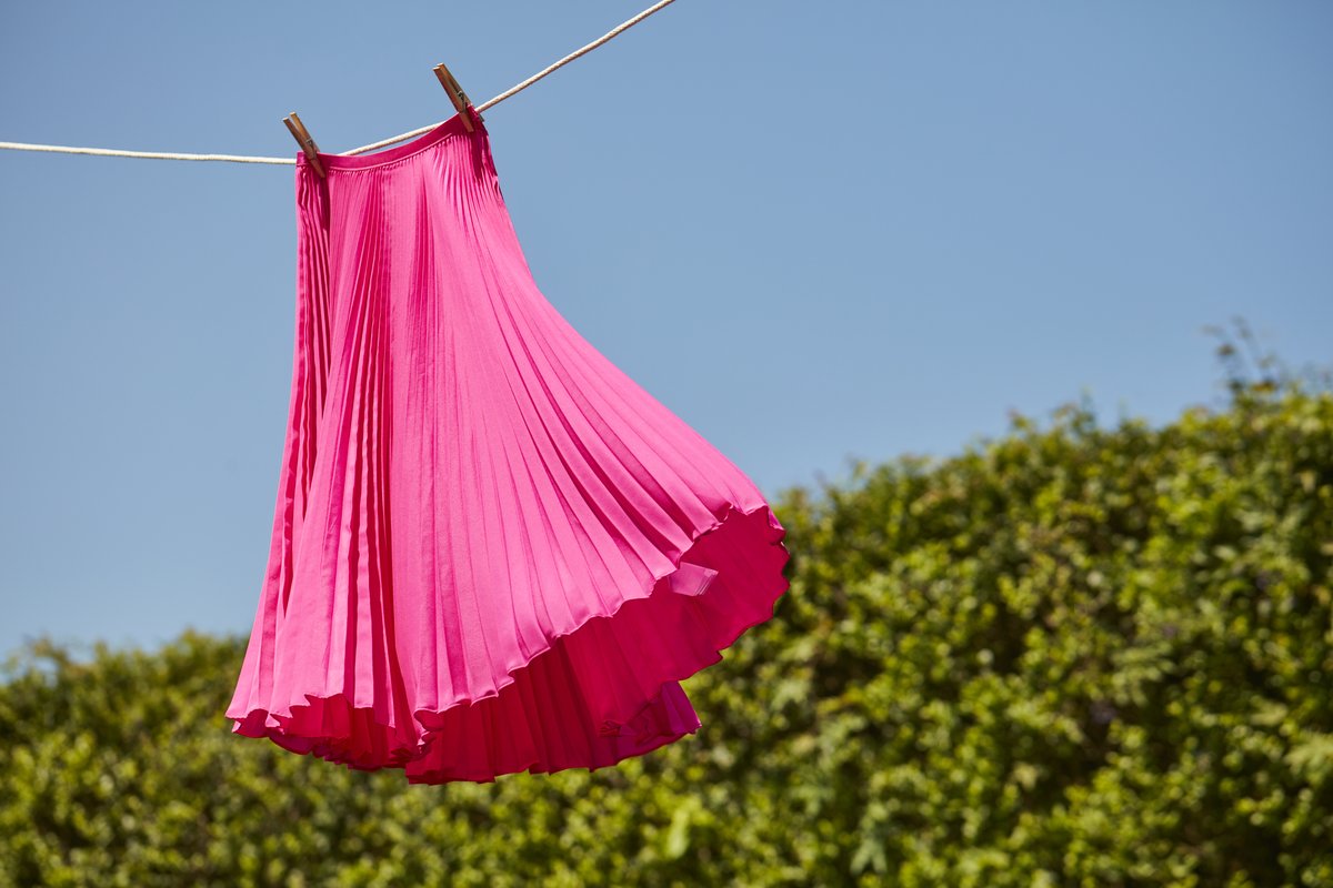 Pleated skirt hanging on clothing line