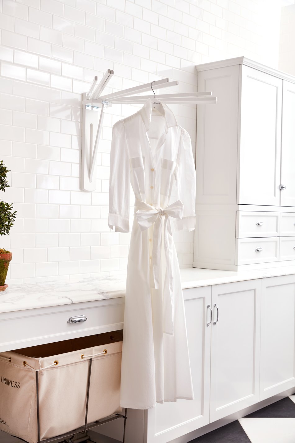 Cotton dress hanging from hanger in laundry room