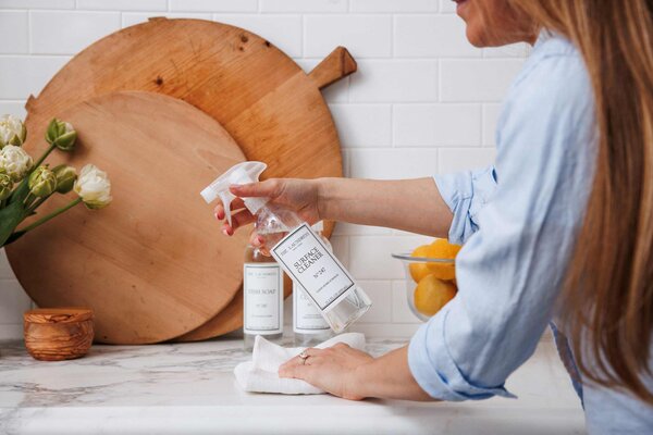 using the laundress surface cleaner to clean marble counter