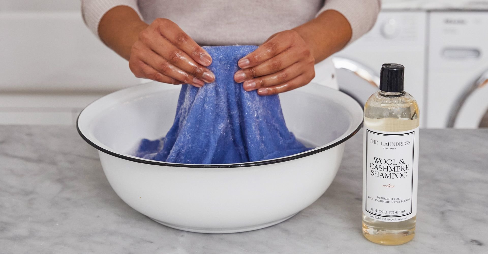 Handwashing blouse in bowl with the laundress wool & cashmere shampoo