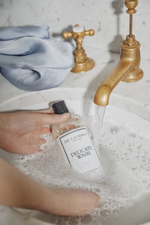 handwashing silk pillowcase in a sink with the laundress delicate wash 