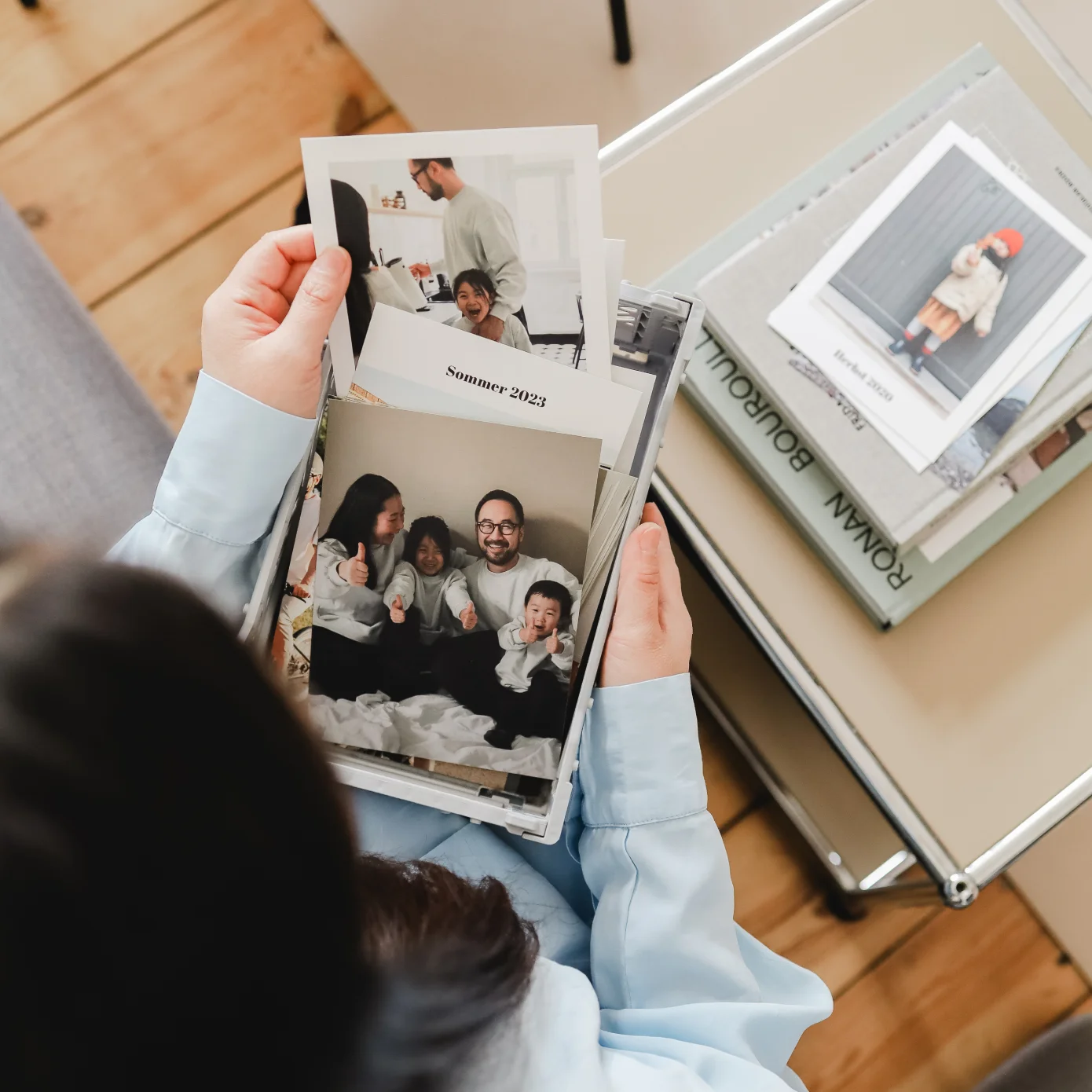 Black haired woman holding Once Upon prints