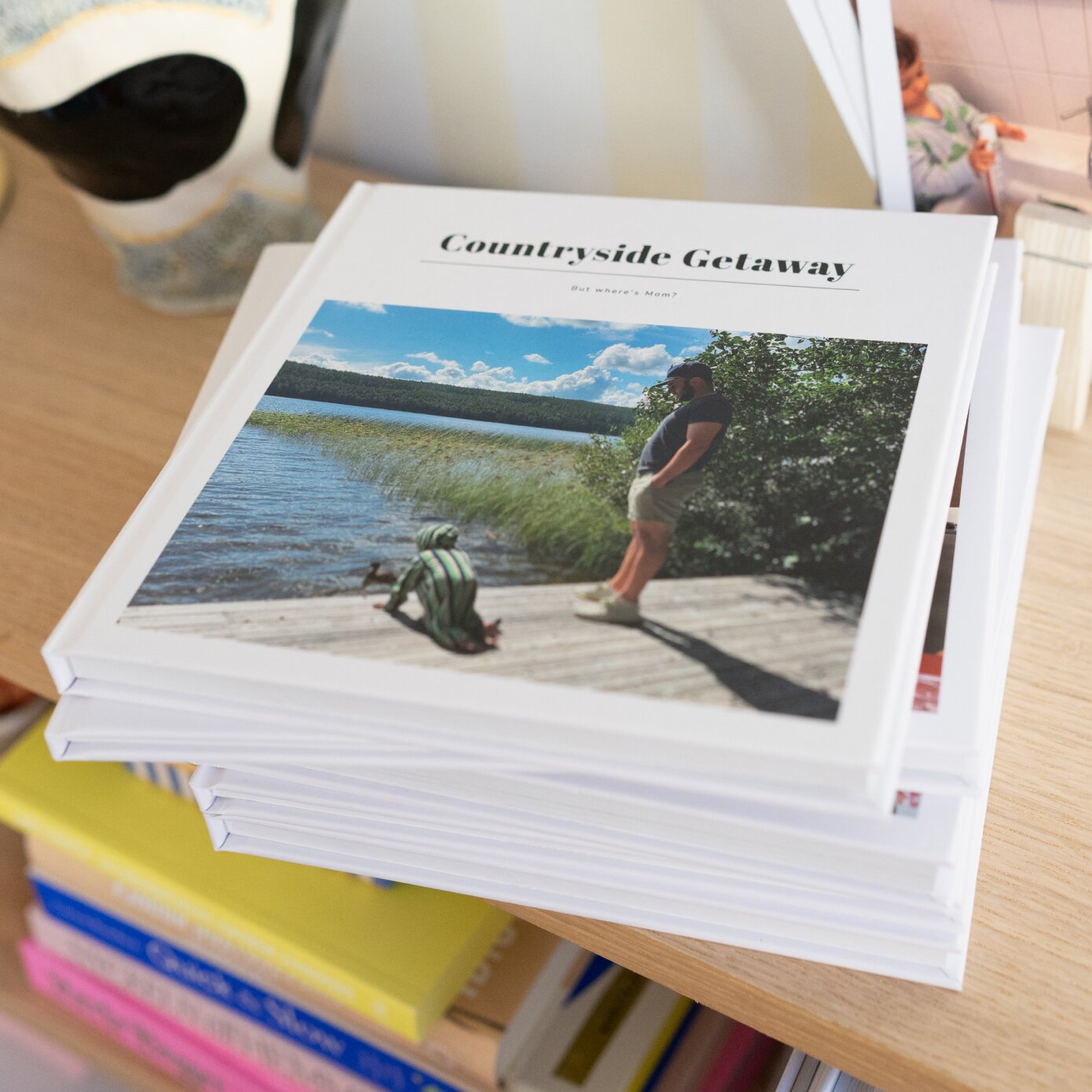 Pile of photobooks on a bookshelf, top book says "Countryside getaway".