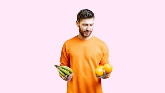 Women holding orange with yellow backgorund