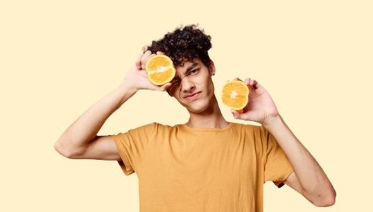 man holding orange cut in half