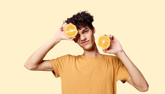 Man holding orange halves