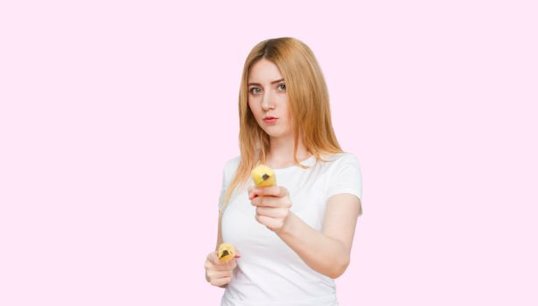 Man holding apple with pink background