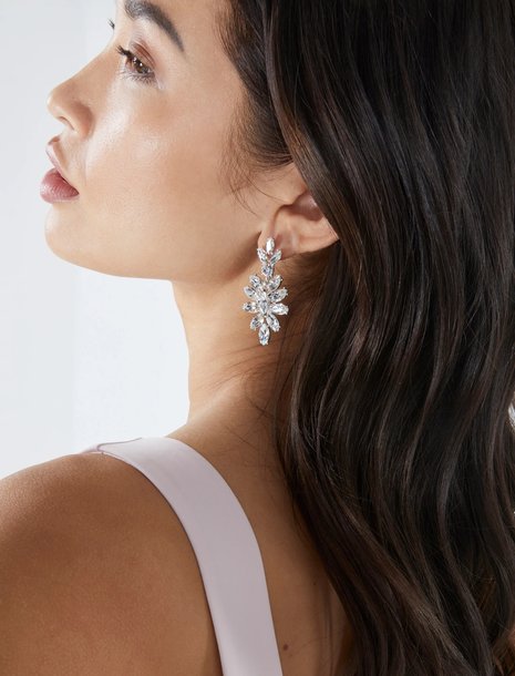 woman wearing silver crystal drop earrings