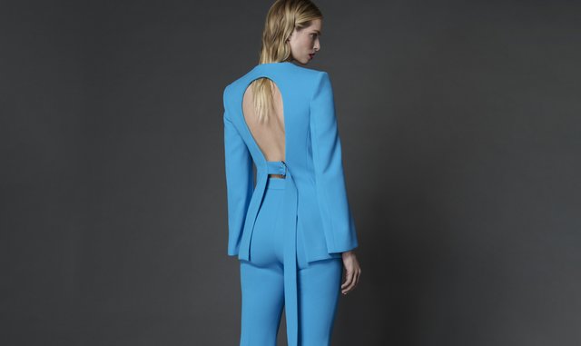 woman in a bright blue suit set with an open back