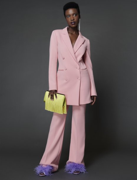 Picture of a woman in a salmon rose pink suit set