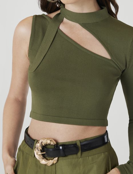 Picture of a woman in an olive green asymmetrical crop top
