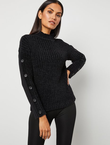 Picture of a woman wearing a black button sleeve sweater