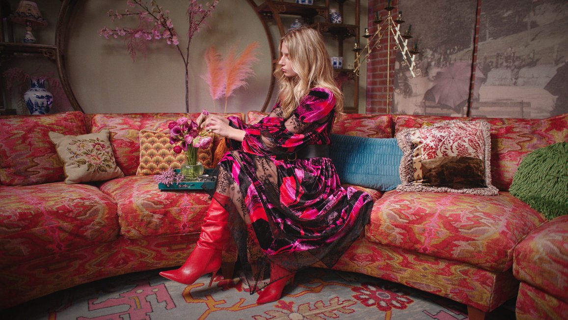 woman in silky satin pink maxi dress with cowl neck and chain details