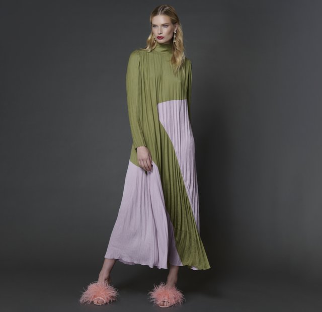 woman in full length olive green and lilac lavender purple pleated long sleeve turtleneck dress