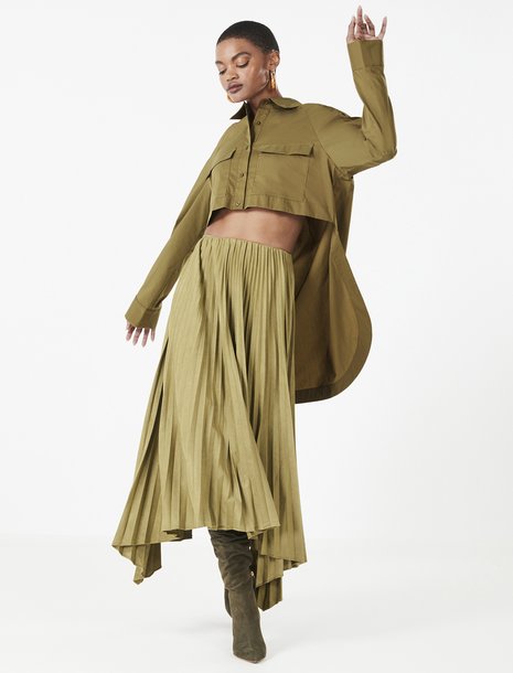 Picture of a woman in an olive green pleated skirt and cropped button down