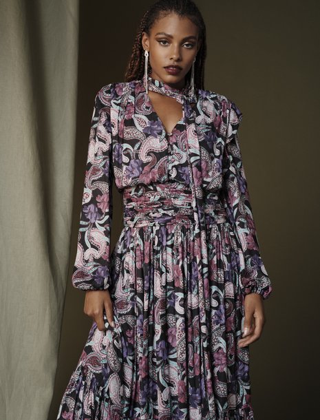 Picture of a women in a dark floral maxi dress