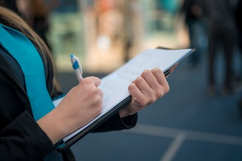 Photo of a woman checking a list.