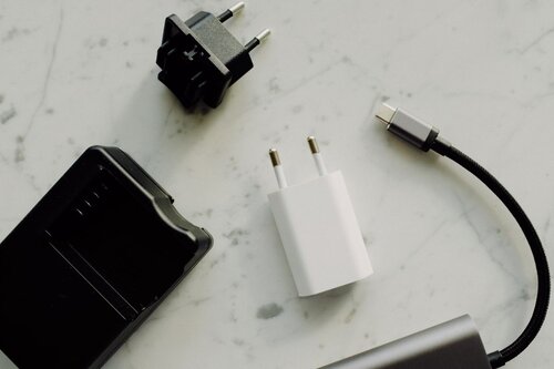 Multiple chargers scattered on a counter.